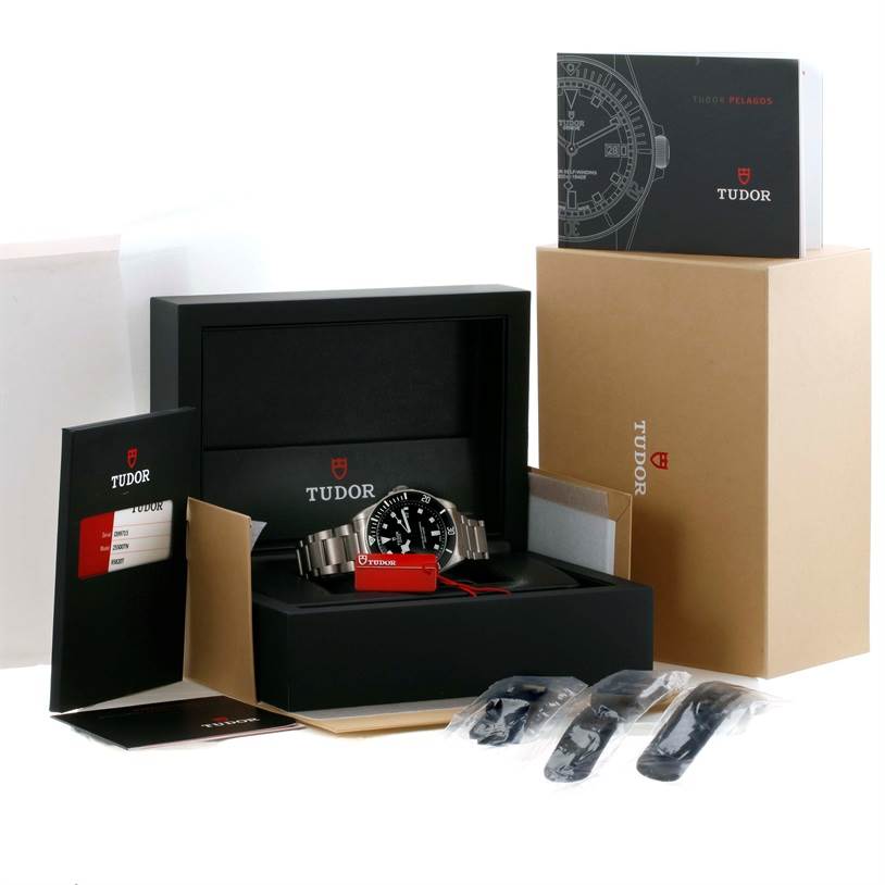 The image shows the Tudor Pelagos 25500TN Men's Titanium Black Dial 25500TN Men's Titanium Black Dial watch with its box, manuals, warranty card, and extra straps, all viewed from a front angle.
