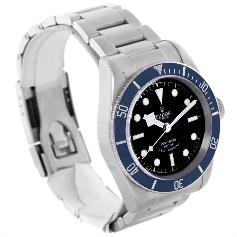 The image shows a Tudor Heritage Black Bay 79220 Men's Stainless Steel Black Dial 79220 Men's Stainless Steel Black Dial watch at an angle displaying the face, bezel, crown, and metal bracelet.