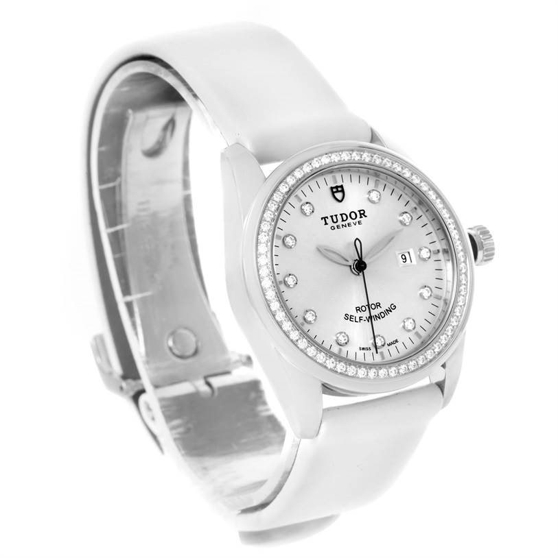 The image shows a Tudor Glamour 53020 Women's Stainless Steel White Dial 53020 Women's Stainless Steel White Dial watch from a front angle, highlighting the face, bezel, case, and partially open white strap.