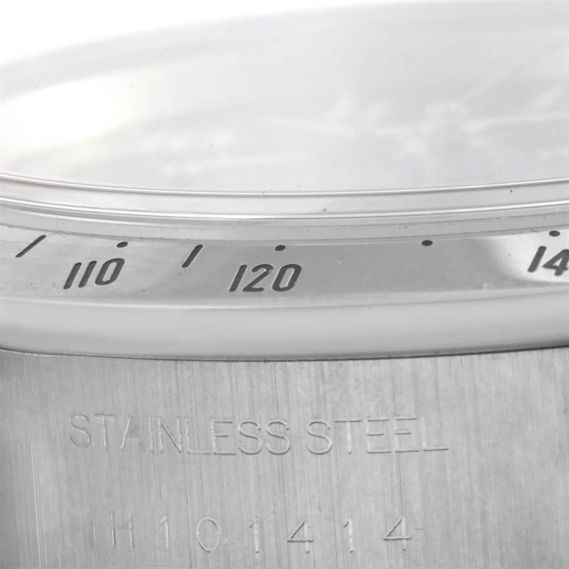 The image shows a close-up of the bezel and stainless steel case back of the Tiger model by Tudor.