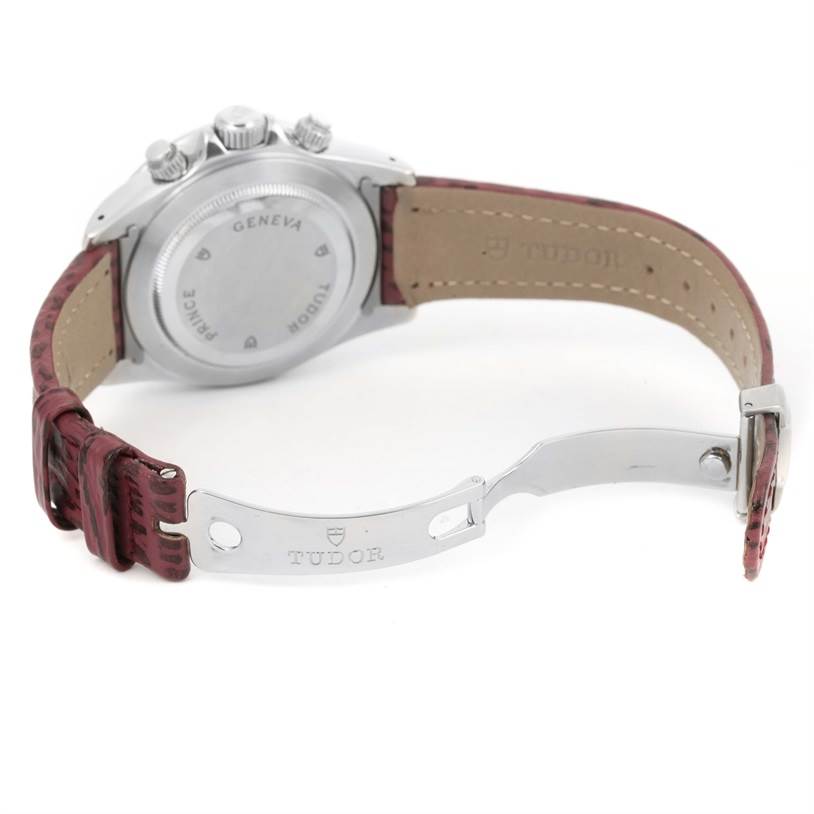 The image shows the back of the Tudor Tiger 79280 Men's Stainless Steel Burgundy Dial 79280 Men's Stainless Steel Burgundy Dial model watch, including its case back, push-buttons, and partially open leather strap with Tudor branding on the clasp.