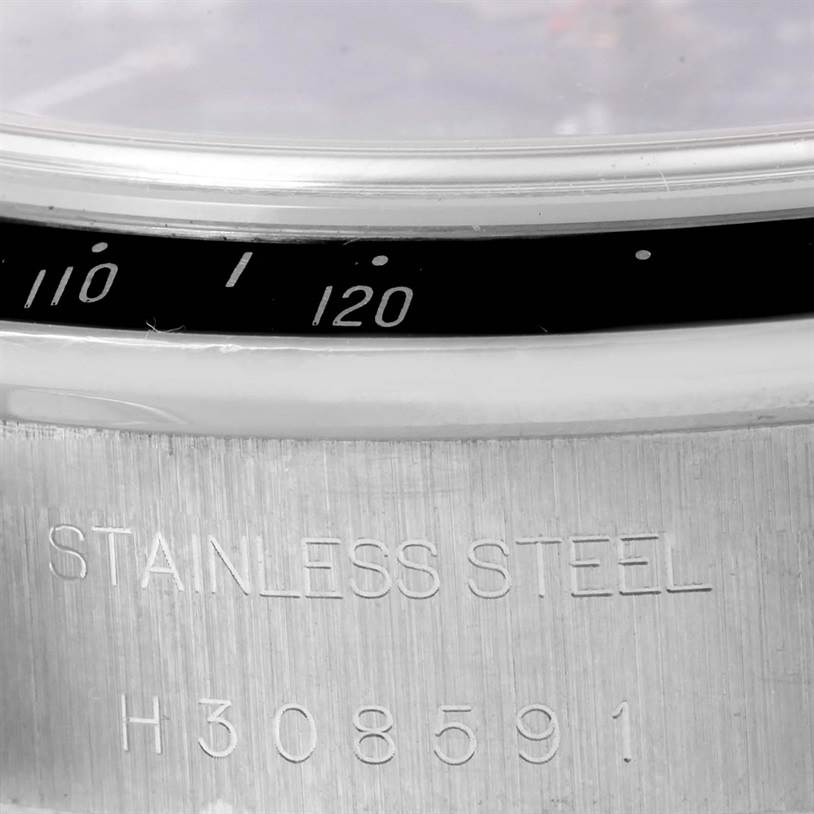 Close-up of the Tudor Prince watch showing part of the bezel with speed markings and the stainless steel case back with engraving.
