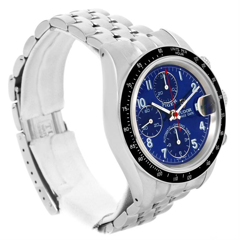 The image shows a Tudor Prince model watch at an angle, highlighting its blue dial, bezel, and stainless steel bracelet.