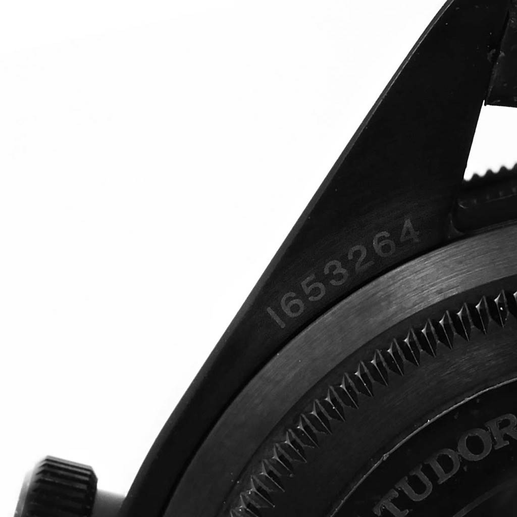 This close-up image of the Tudor Heritage Black Bay 79230DK Men's Stainless Steel Black Dial 79230DK Men's Stainless Steel Black Dial shows part of the case back and the serial number.