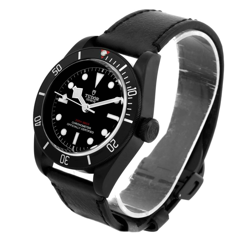 The image shows a Tudor Heritage Black Bay 79230DK Men's Stainless Steel Black Dial 79230DK Men's Stainless Steel Black Dial watch at a slight angle, highlighting its face, bezel, crown, and leather strap.