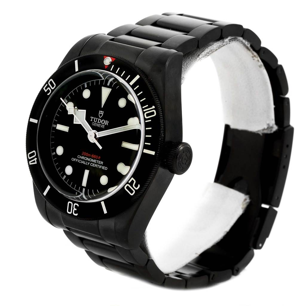 The image shows a Tudor Heritage Black Bay 79230DK Men
s Stainless Steel Black Dial 79230DK Men
s Stainless Steel Black Dial watch angled to display the face, bezel, crown, and bracelet.