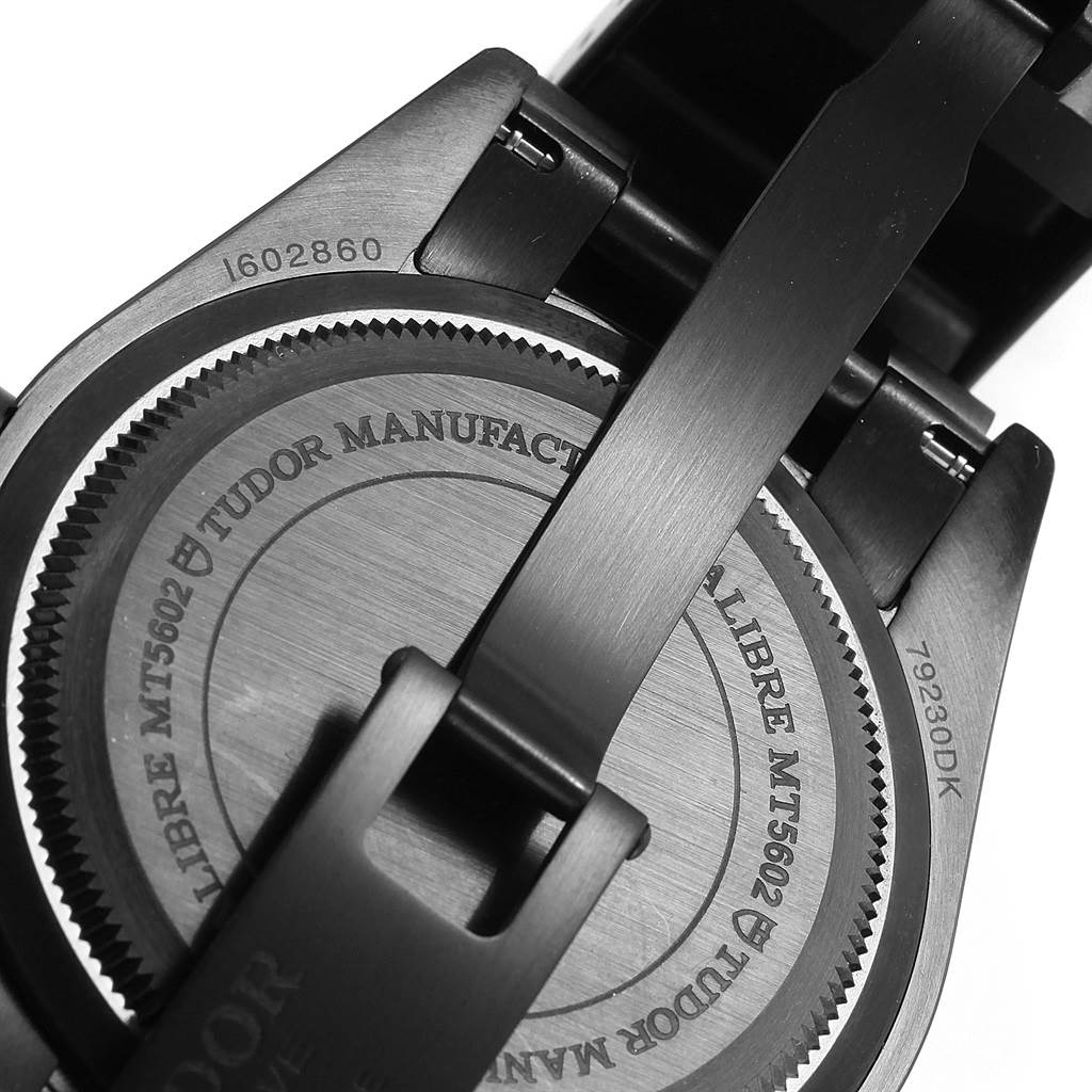 The image shows the back case and part of the bracelet of a Tudor Heritage Black Bay 79230DK Men
s Stainless Steel Black Dial 79230DK Men
s Stainless Steel Black Dial watch.