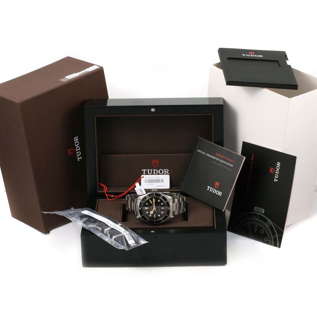 The image shows a Tudor Heritage Black Bay 79230N Men's Stainless Steel Black Dial 79230N Men's Stainless Steel Black Dial watch with its box, extra links, manuals, and original packaging from a front angle.