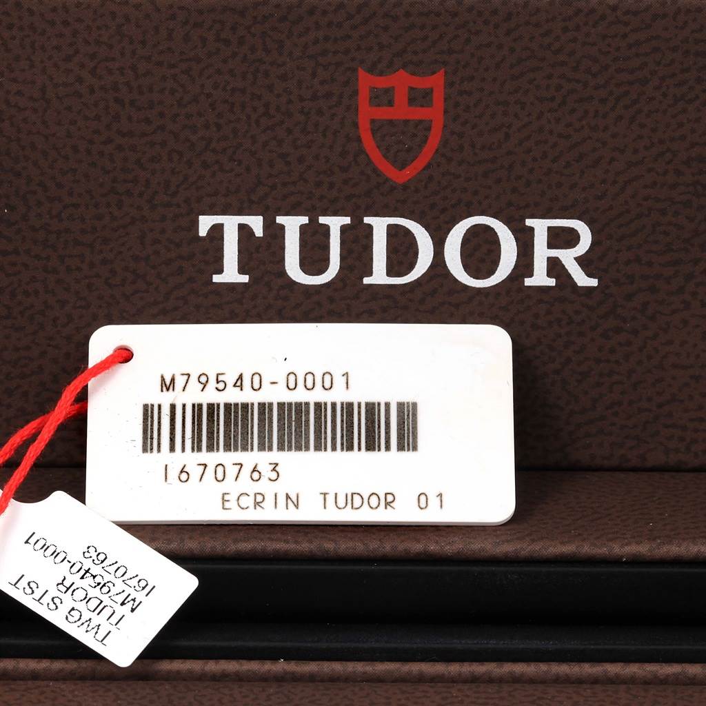 This image shows the packaging and labels of a Tudor Heritage Black Bay 79540 Men
s Stainless Steel Black Dial 79540 Men
s Stainless Steel Black Dial watch, including the model number M79540-0001.