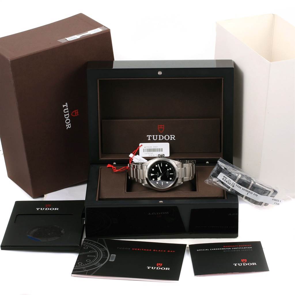 The image shows a Tudor Heritage Black Bay 79540 Men
s Stainless Steel Black Dial 79540 Men
s Stainless Steel Black Dial watch in its box with all accessories, manuals, and additional bracelet links.