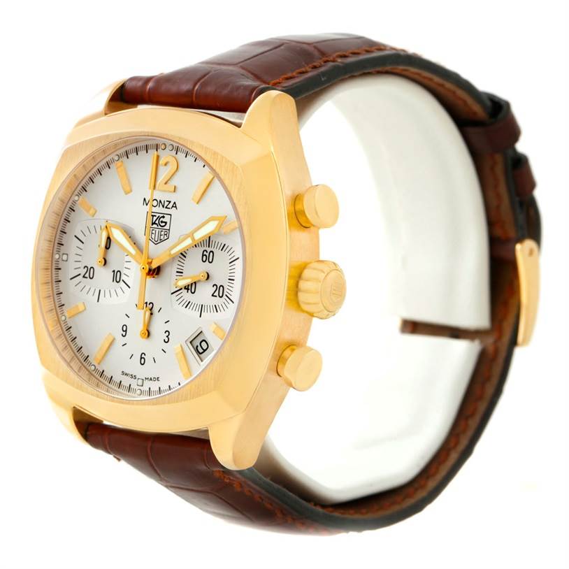 The Tag Heuer Monza CR514A.FC8145 Men's Yellow Gold Silver Dial CR514A.FC8145 Men's Yellow Gold Silver Dial watch is shown at a slight side angle, displaying its gold case, dial, crown, pushers, and brown leather strap.