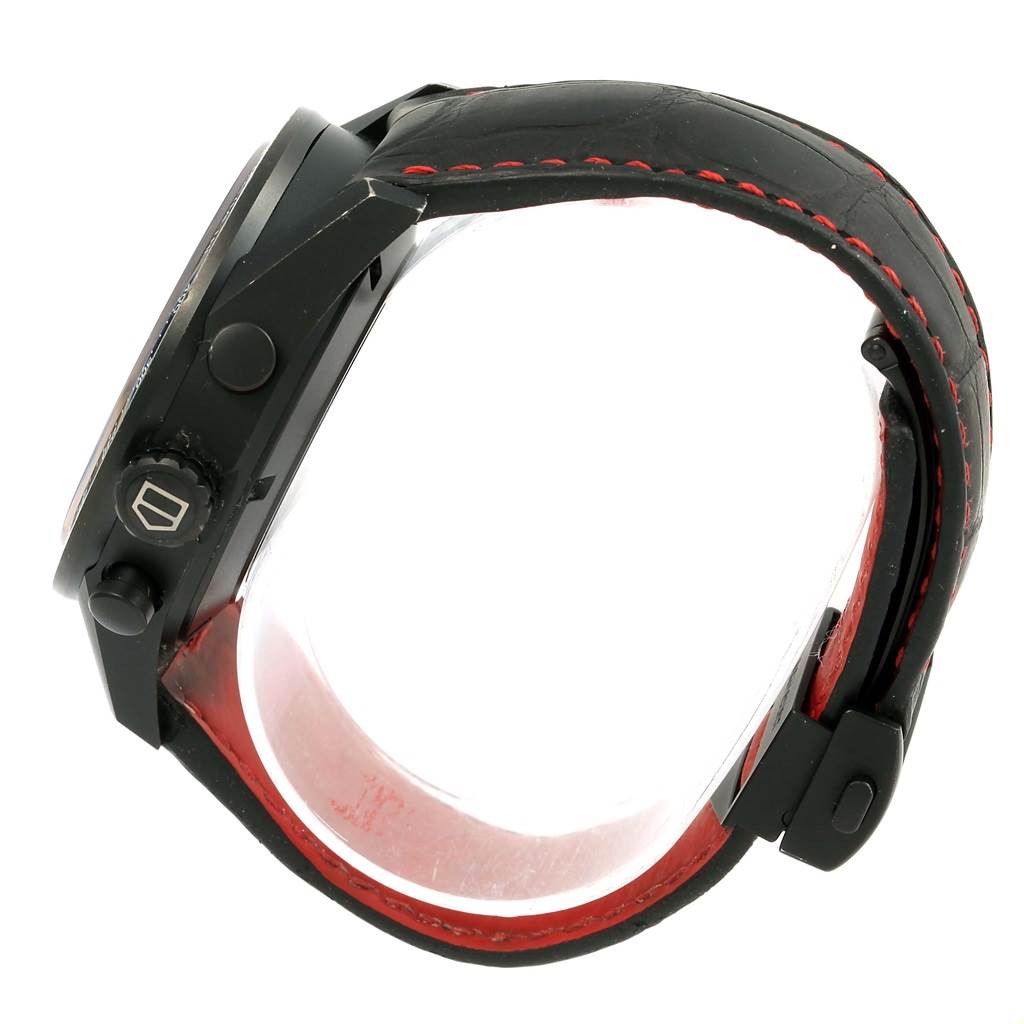 The image shows a side view of a Tag Heuer Carrera CAR2A80-FC6237 Men's Titanium Black Dial CAR2A80-FC6237 Men's Titanium Black Dial watch, focusing on the crown, pushers, and black leather strap with red stitching.