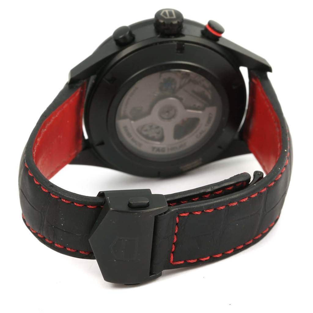 The image shows the back view of a Tag Heuer Carrera CAR2A80-FC6237 Men's Titanium Black Dial CAR2A80-FC6237 Men's Titanium Black Dial watch with a black leather strap and red stitching.