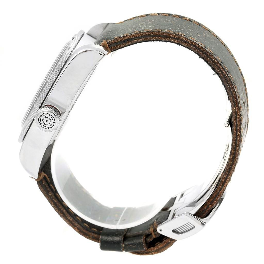 The image shows the side view of a Tudor Heritage Black Bay 79220R Men's Stainless Steel Black Dial 79220R Men's Stainless Steel Black Dial watch, highlighting its case, crown, and a leather strap.