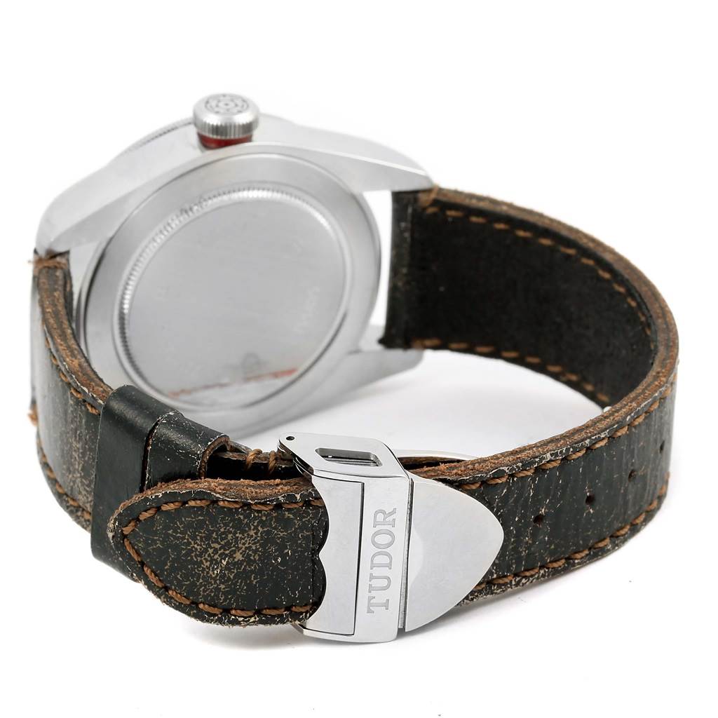 The image shows the back of the Tudor Heritage Black Bay 79220R Men's Stainless Steel Black Dial 79220R Men's Stainless Steel Black Dial watch, featuring the stainless steel case and leather strap with buckle.