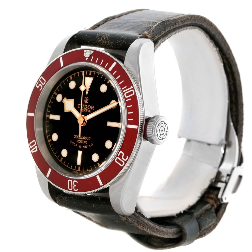 This Tudor Heritage Black Bay 79220R Men's Stainless Steel Black Dial 79220R Men's Stainless Steel Black Dial watch is shown from an angle displaying the dial, bezel, crown, and strap.