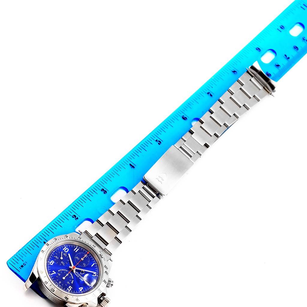 The Tudor Tiger 79280 Men's Stainless Steel Blue Dial 79280 Men's Stainless Steel Blue Dial watch is shown laid flat with its bracelet extended next to a blue ruler for measurement.