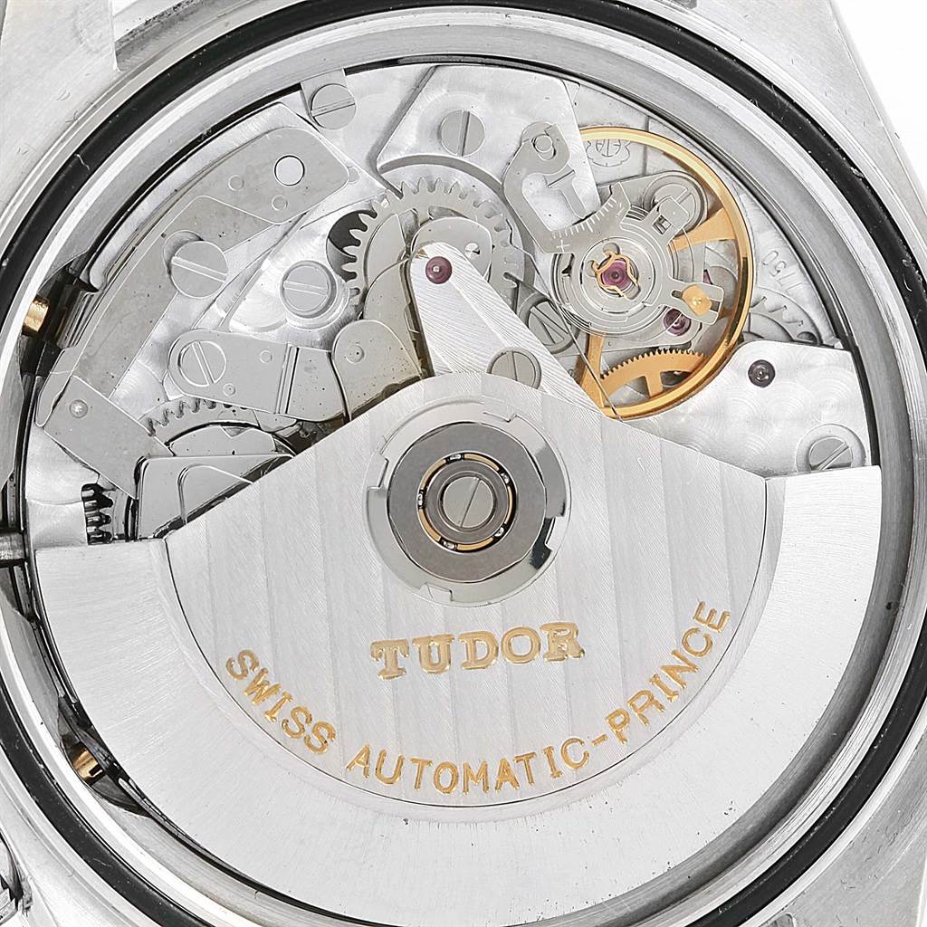 The image shows the movement mechanism of the Tudor Tiger 79280 Men's Stainless Steel Blue Dial 79280 Men's Stainless Steel Blue Dial watch, featuring gears, springs, and the winding rotor engraved with "Tudor."