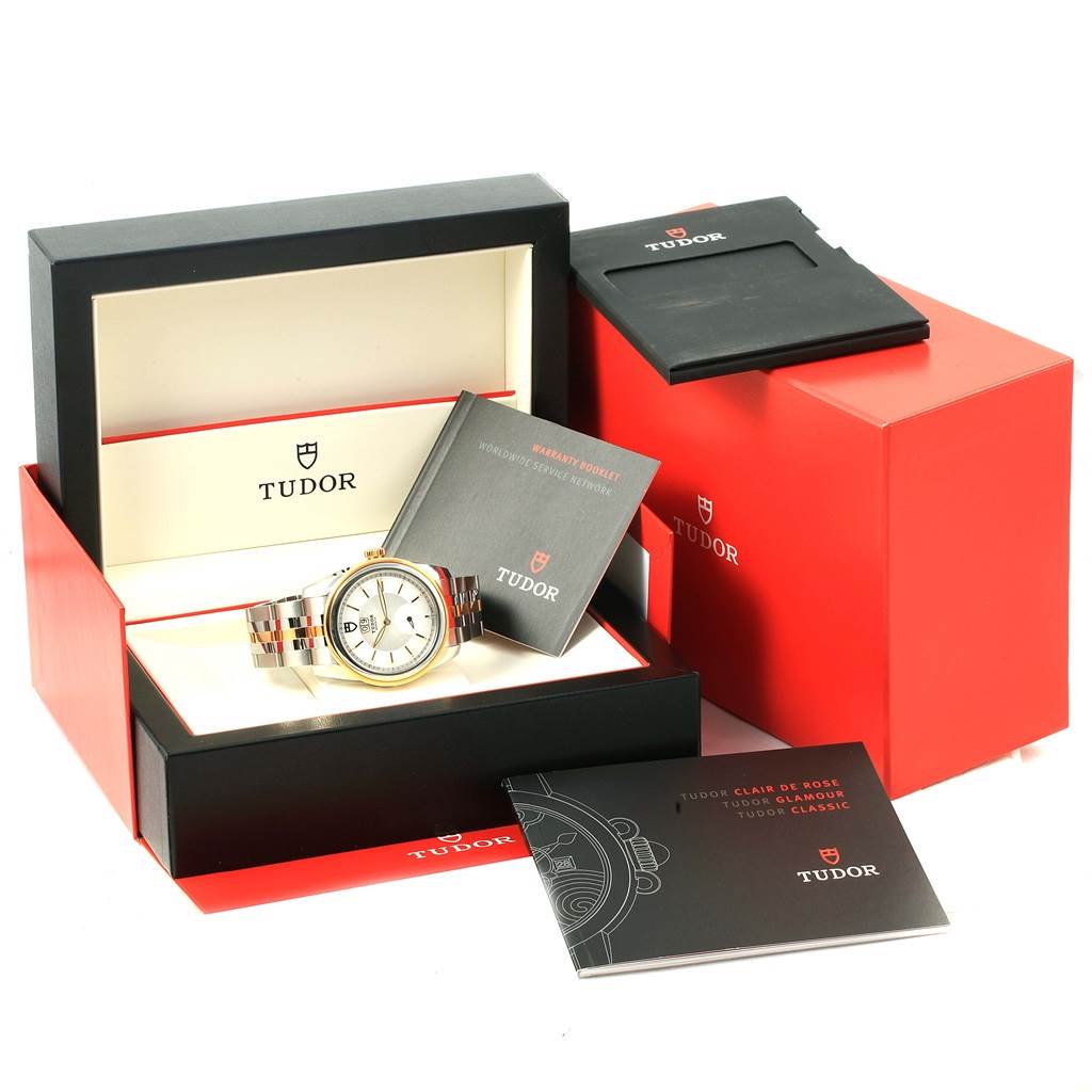 The image shows a Tudor Glamour 57003-0006 Men's Steel and Gold (two tone) Silver Dial 57003-0006 Men's Steel and Gold (two tone) Silver Dial watch in its box, accompanied by manuals and packaging.
