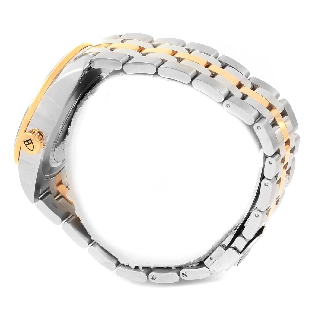 This image shows a side view of the Tudor Glamour 57003-0006 Men's Steel and Gold (two tone) Silver Dial 57003-0006 Men's Steel and Gold (two tone) Silver Dial watch, highlighting its crown and metal bracelet.