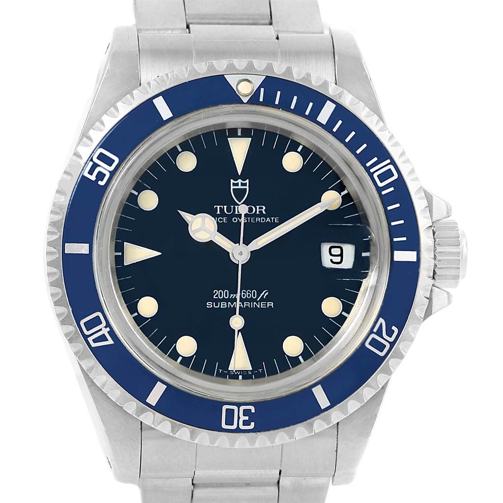 This image shows a front view of the Tudor Submariner 79090 Men's Stainless Steel Black Dial 79090 Men's Stainless Steel Black Dial watch with a blue bezel, black dial, and metal bracelet.