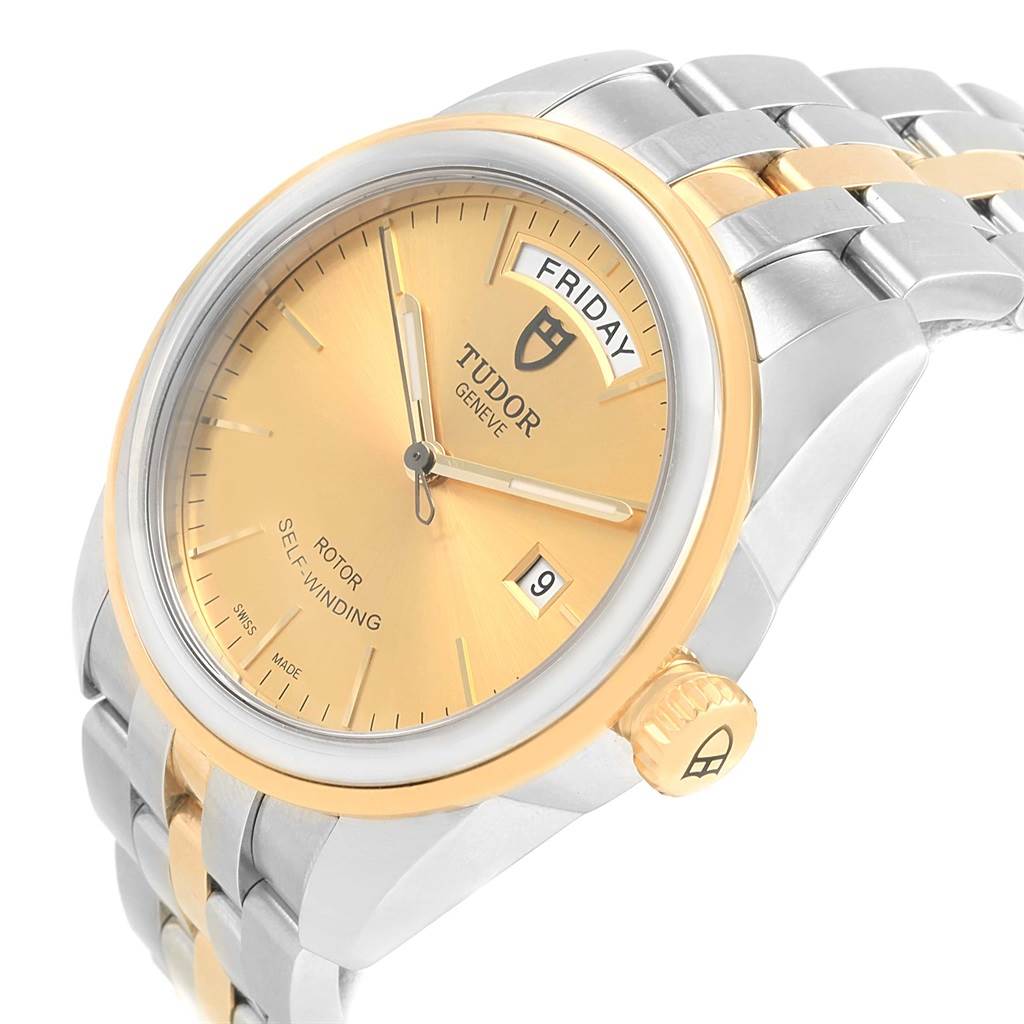 The Tudor Glamour 56003 Men's Steel and Gold (two tone) Champagne Dial 56003 Men's Steel and Gold (two tone) Champagne Dial watch is shown at a slight side angle, highlighting the gold dial, day-date display, and two-tone bracelet.