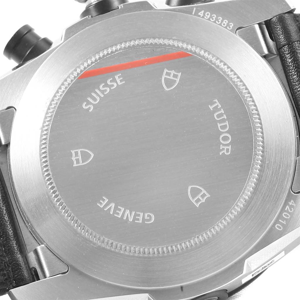 The image shows the back case of a Tudor Fastrider 42010N Men
s Stainless Steel Green Dial 42010N Men
s Stainless Steel Green Dial watch, highlighting the engraved details and serial number.