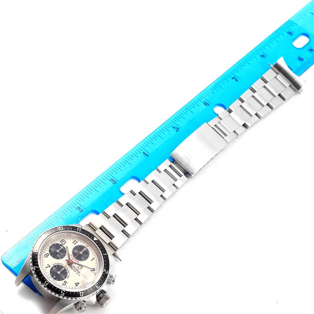 The Tudor Tiger 79270 Men's Stainless Steel White Dial 79270 Men's Stainless Steel White Dial model watch is shown lying flat with its dial and bracelet fully visible, next to a blue ruler.
