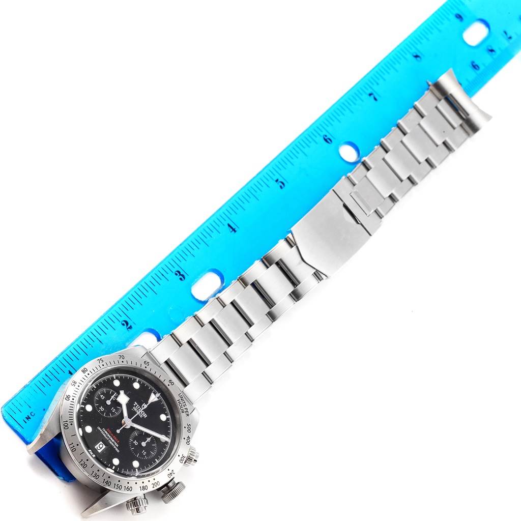 The image shows a Tudor Heritage Black Bay 79350 Men's Stainless Steel Black Dial 79350 Men's Stainless Steel Black Dial watch with a full view of the stainless steel bracelet and a partial view of the face, measured against a ruler.