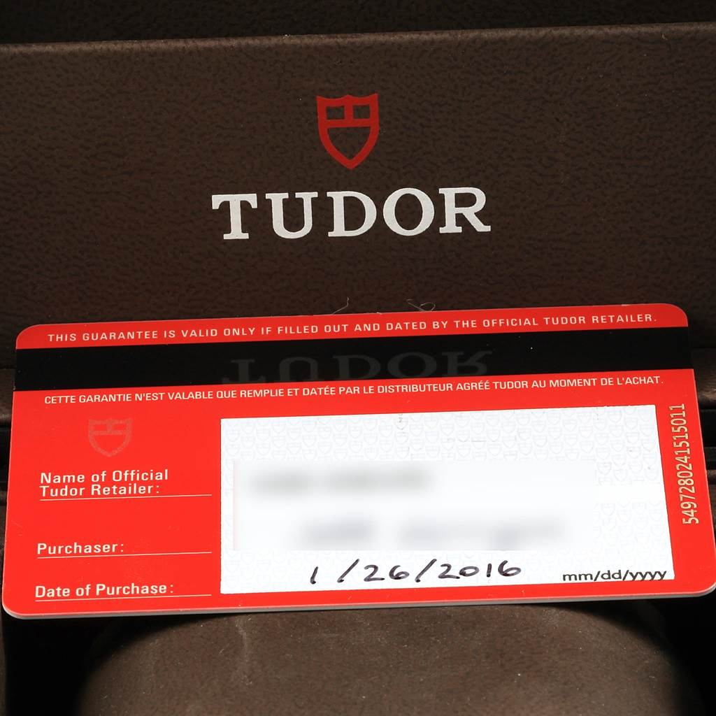 This image shows a warranty card for the Tudor Heritage Black Bay 79220N Men's Stainless Steel Black Dial 79220N Men's Stainless Steel Black Dial watch against a Tudor-branded background.