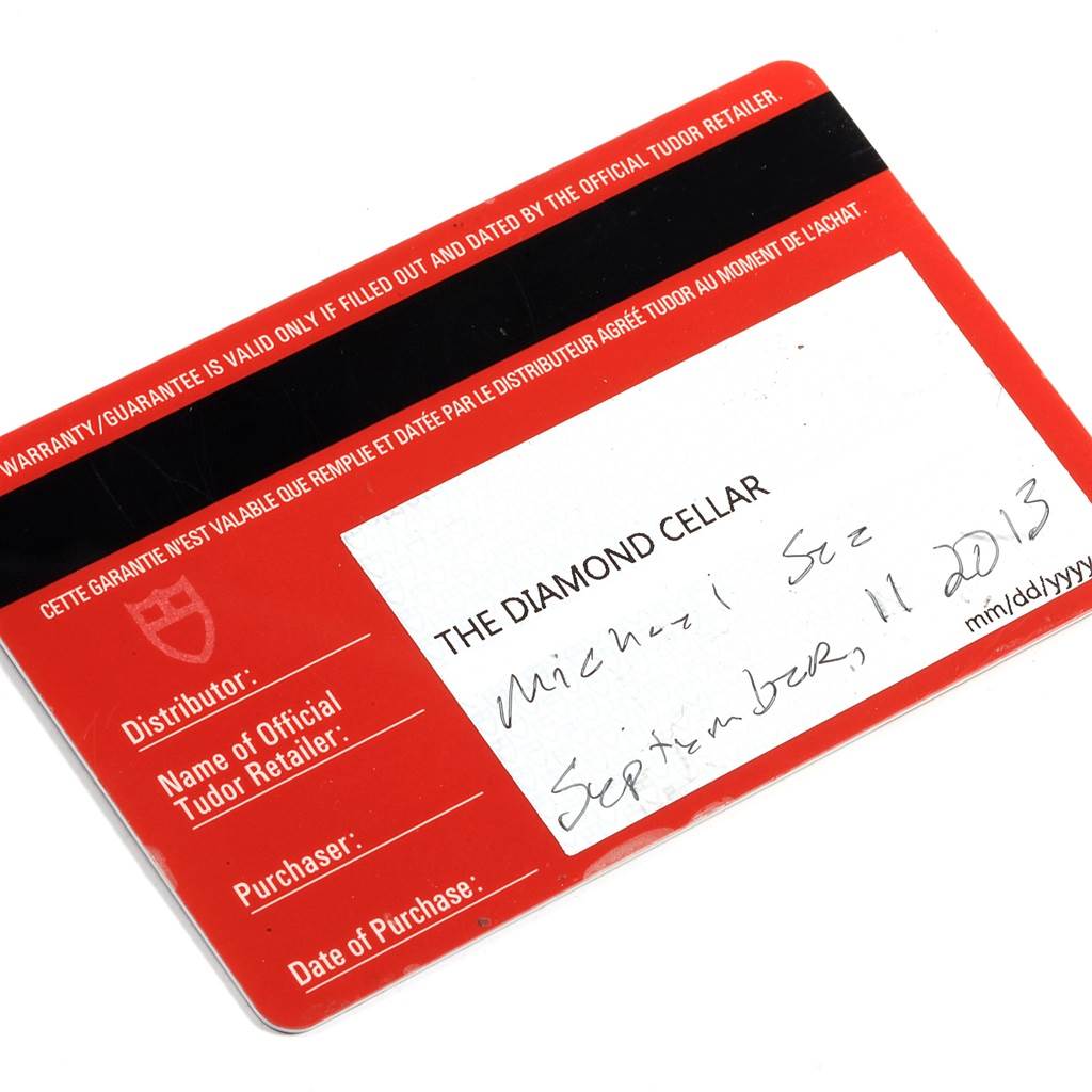 The image shows a warranty card for a Tudor Heritage Chrono 70330 Men's Stainless Steel Blue Dial 70330 Men's Stainless Steel Blue Dial watch, partially completed with handwritten details.