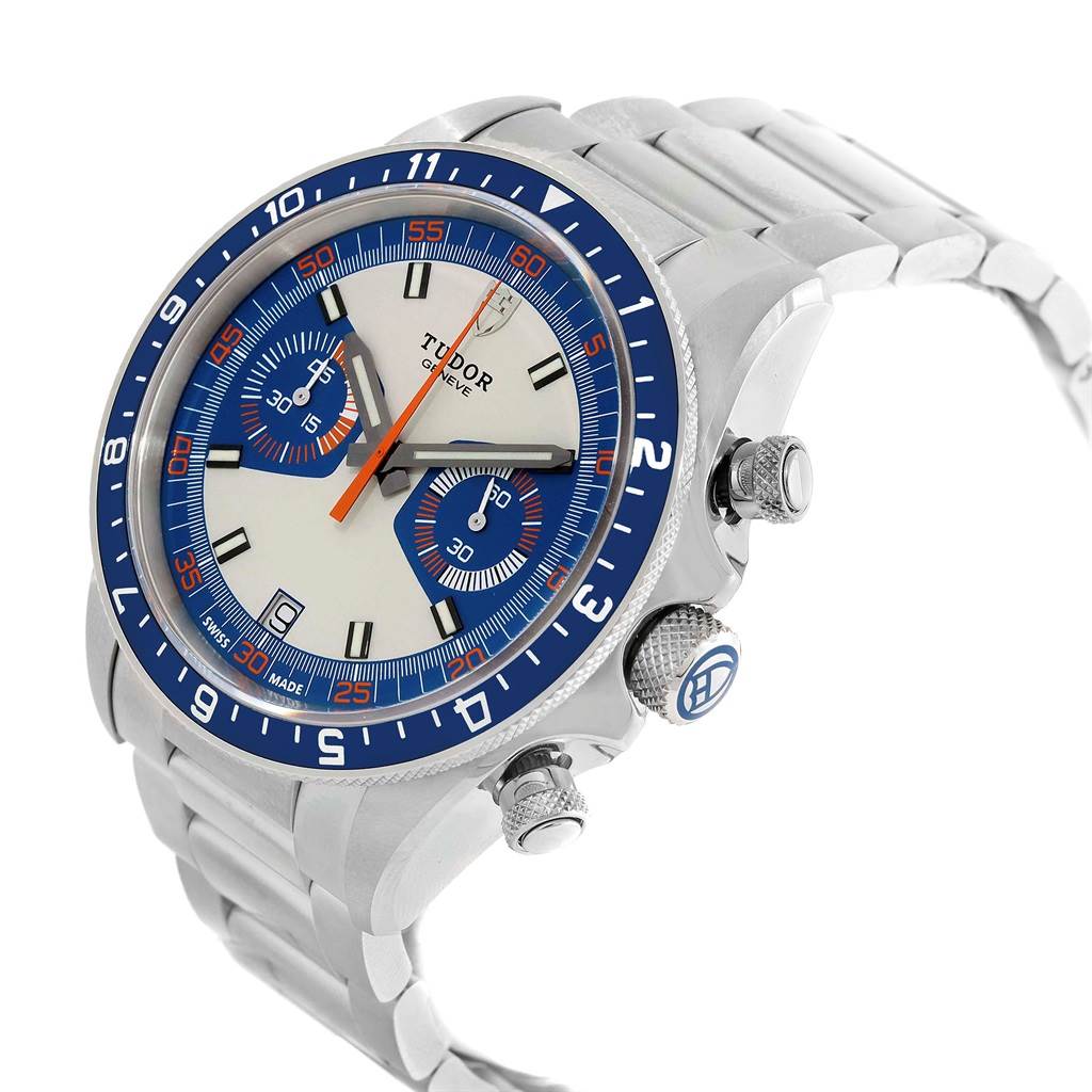The Tudor Heritage Chrono 70330 Men's Stainless Steel Blue Dial 70330 Men's Stainless Steel Blue Dial watch is shown from a slightly angled side view, displaying its face, bezel, crown, and part of the bracelet.
