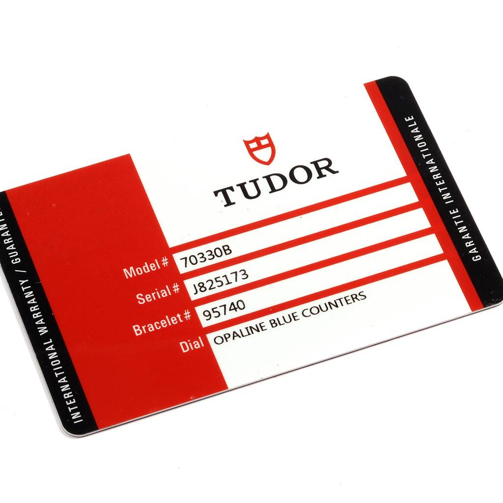 The image shows the international warranty card for a Tudor Heritage Chrono 70330 Men's Stainless Steel Blue Dial 70330 Men's Stainless Steel Blue Dial watch, displaying the model, serial, bracelet, and dial information.