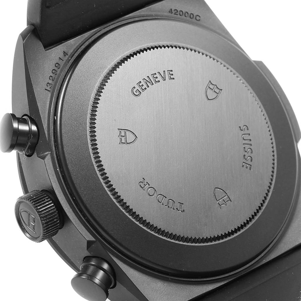 The image shows the back case and buttons of a Tudor Fastrider 42000CR-0002 Men's Stainless Steel Black Dial 42000CR-0002 Men's Stainless Steel Black Dial watch, focusing on the case back engravings and crown.