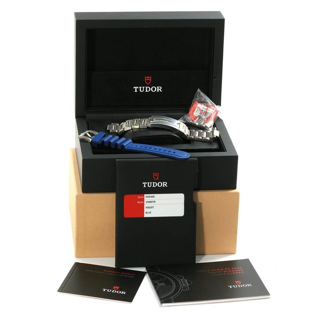 The image shows the Tudor Pelagos 25600TB Men's Titanium Blue Dial 25600TB Men's Titanium Blue Dial watch accessories, including a blue rubber strap, stainless steel bracelet, and original packaging, from a front angle.