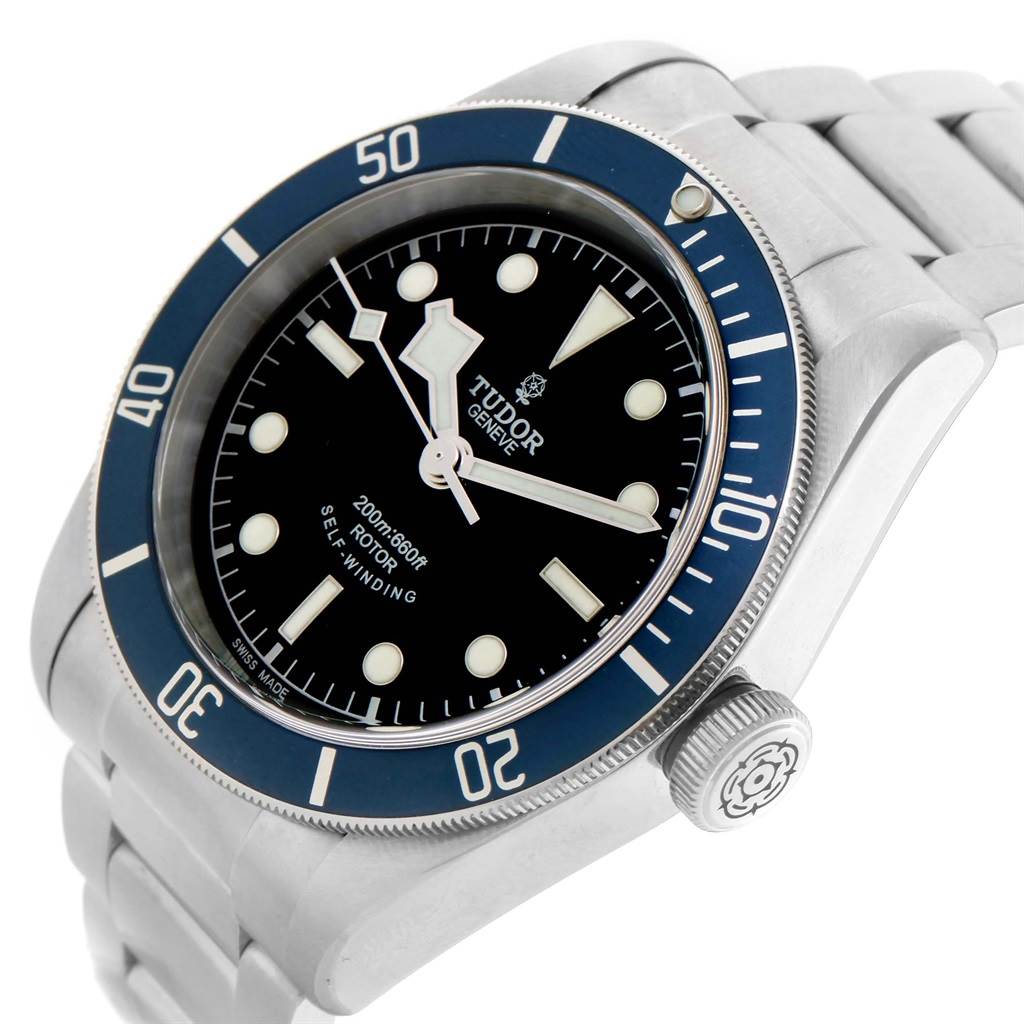 The image shows a Heritage Black Bay model by Tudor at an angle highlighting the face, bezel, and bracelet.