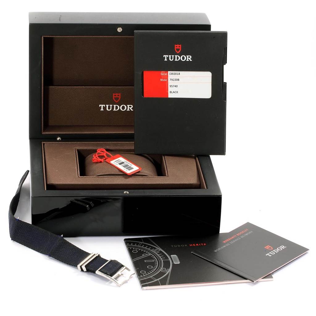 This image shows the Tudor Heritage Black Bay 79220B Men
s Stainless Steel Black Dial 79220B Men
s Stainless Steel Black Dial
s packaging, accessories, strap, tags, and manuals from a front angle.