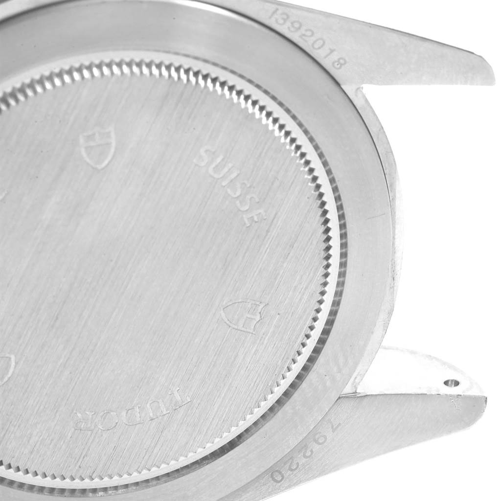 The image shows the back case of the Tudor Heritage Black Bay 79220B Men
s Stainless Steel Black Dial 79220B Men
s Stainless Steel Black Dial watch, focusing on the engraving and the lugs.