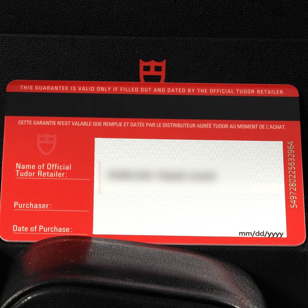 The image displays a guarantee card for a Tudor Pelagos 25500TN Men's Titanium Black Dial 25500TN Men's Titanium Black Dial watch, showing retailer, purchaser fields, and date of purchase.