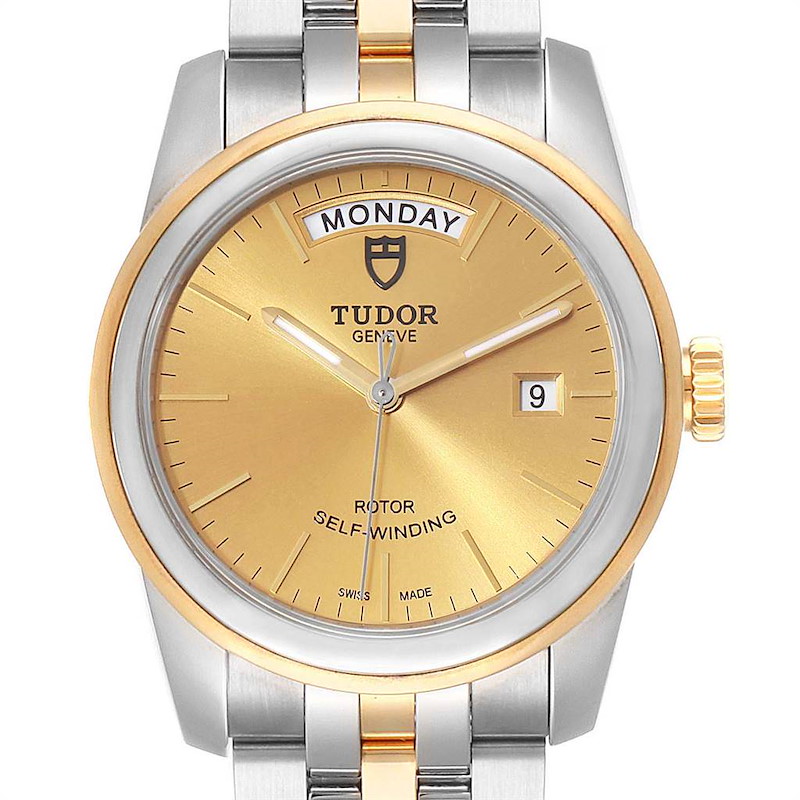 The Tudor Glamour model watch is shown from a front angle, highlighting its gold dial, day/date display, and two-tone bracelet.