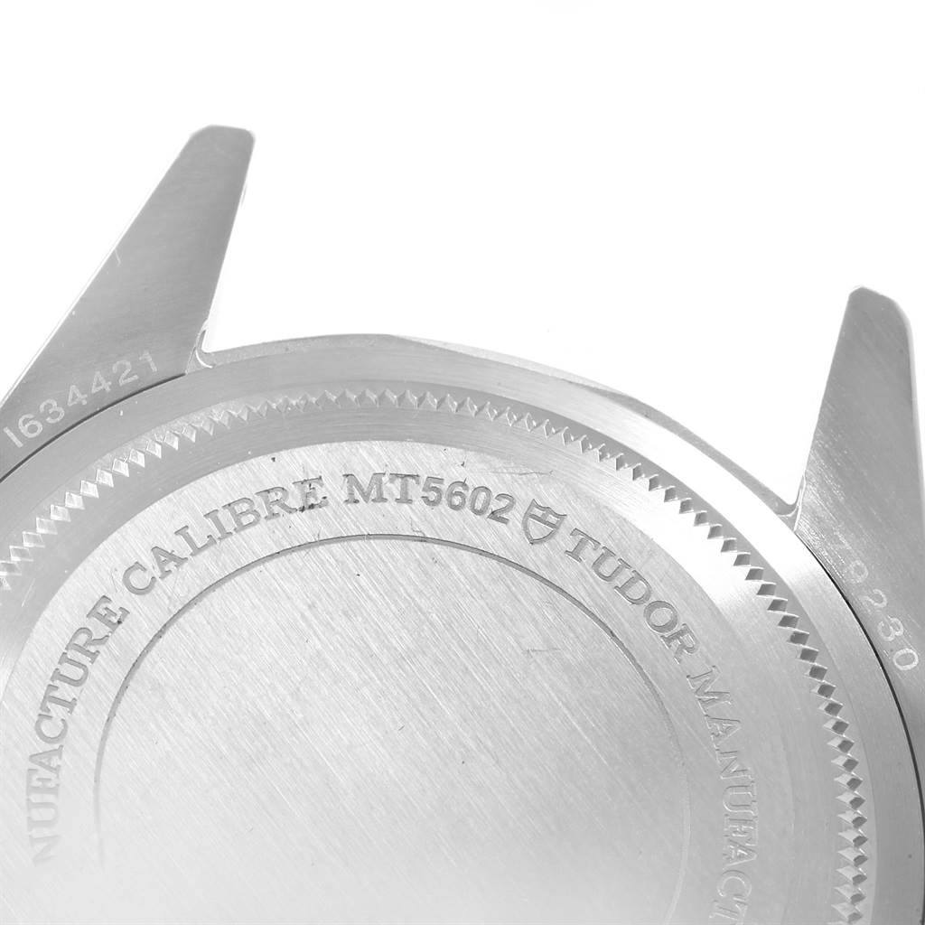 The image shows the back case and lugs of a Tudor Heritage Black Bay 79230N Men's Stainless Steel Black Dial 79230N Men's Stainless Steel Black Dial watch, highlighting the engravings.