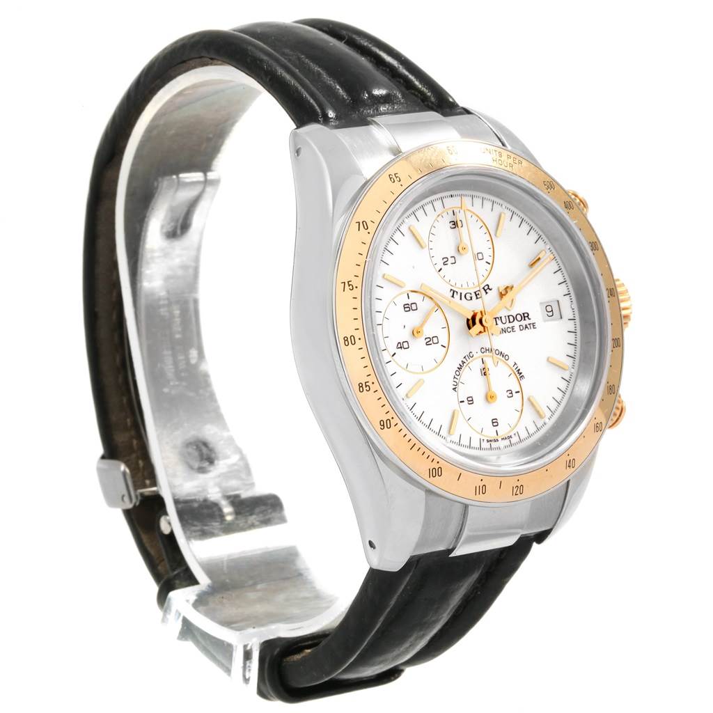 The image shows a side-angle view of the Tudor Tiger 79263 Men's Steel and Gold (two tone) White Dial 79263 Men's Steel and Gold (two tone) White Dial model watch, highlighting its face, bezel, crown, and leather strap.