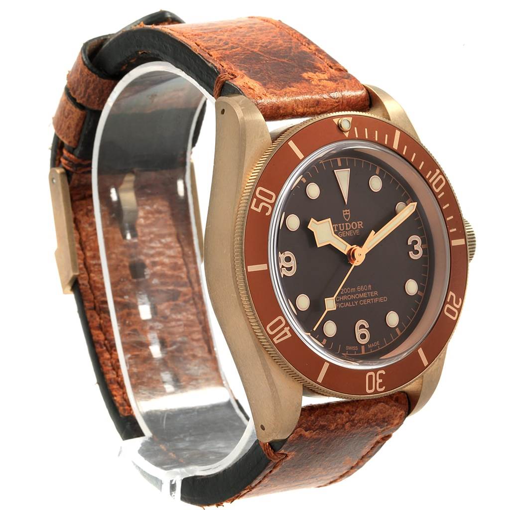 The image showcases a Tudor Heritage Black Bay 79250 Men's Bronze Brown Dial 79250 Men's Bronze Brown Dial watch from an angled side view, highlighting the bezel and leather strap.