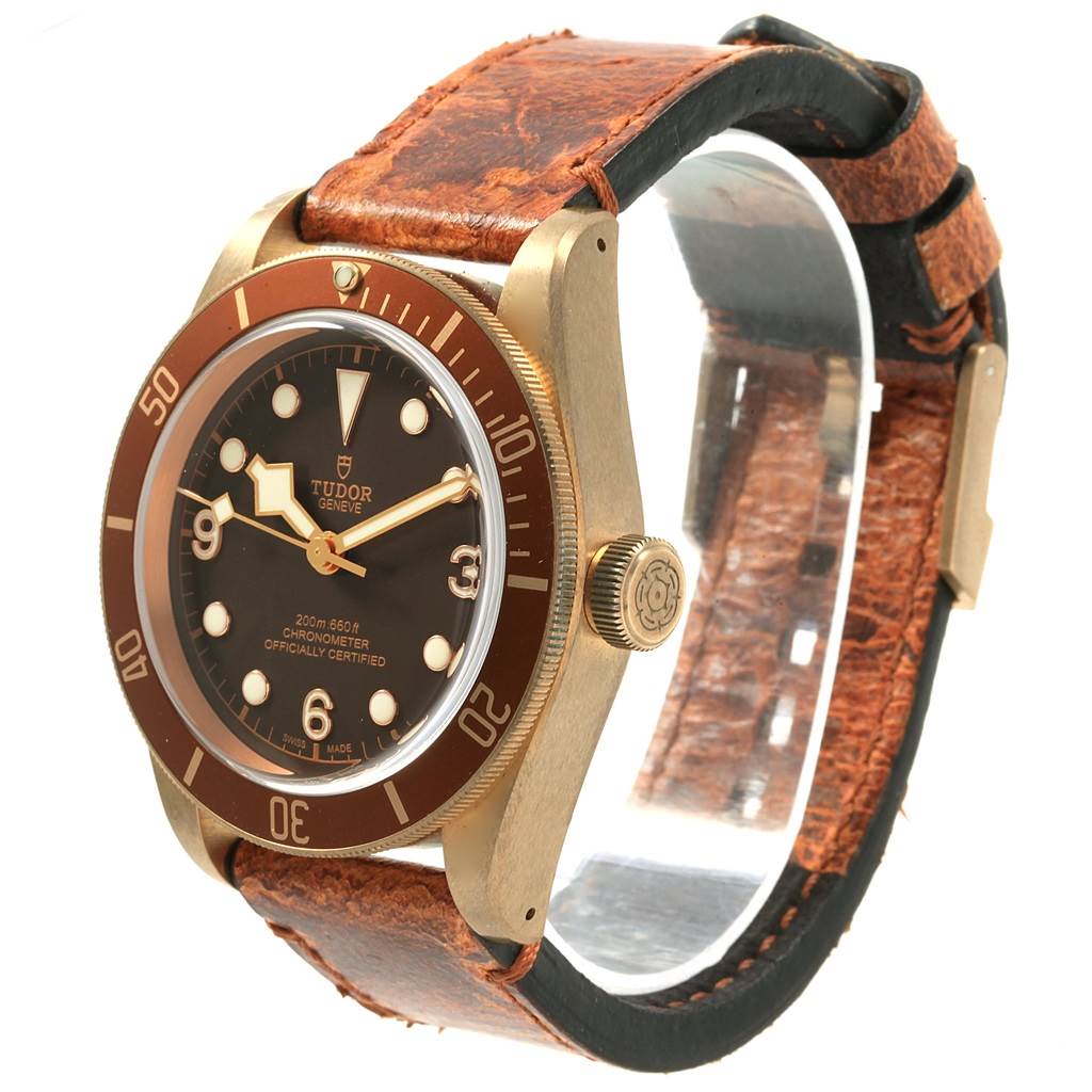 This image shows a Tudor Heritage Black Bay 79250 Men's Bronze Brown Dial 79250 Men's Bronze Brown Dial watch taken from a 3/4 angle highlighting the face, bezel, crown, and leather strap.