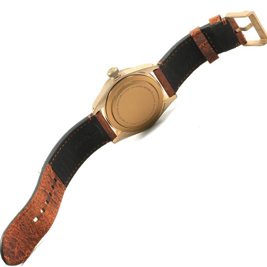The image shows the back view and strap of a Tudor Heritage Black Bay 79250 Men's Bronze Brown Dial 79250 Men's Bronze Brown Dial watch, highlighting the case back and leather strap.
