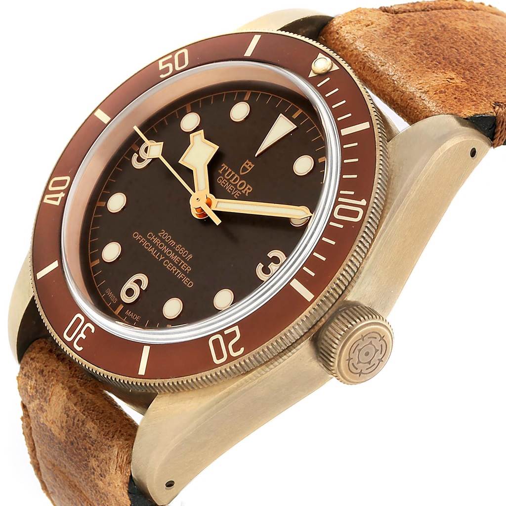 The image shows a Tudor Heritage Black Bay 79250B Men's Bronze Brown Dial 79250B Men's Bronze Brown Dial watch angled to display its face, bezel, crown, and leather strap.