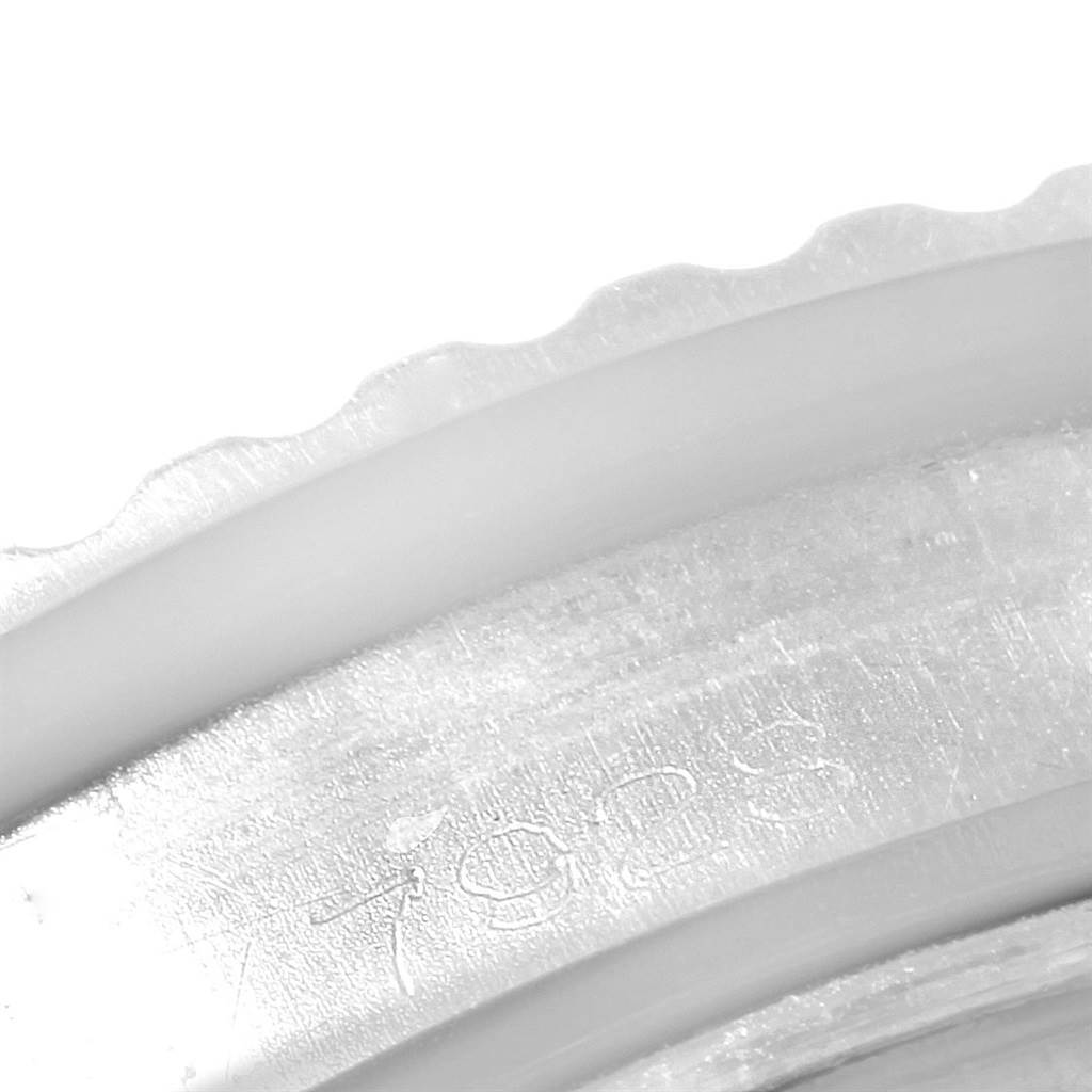 This close-up image shows a partial view of the bezel and engraved serial number of a Tudor Submariner 7928 Men's Stainless Steel Black Dial 7928 Men's Stainless Steel Black Dial watch.