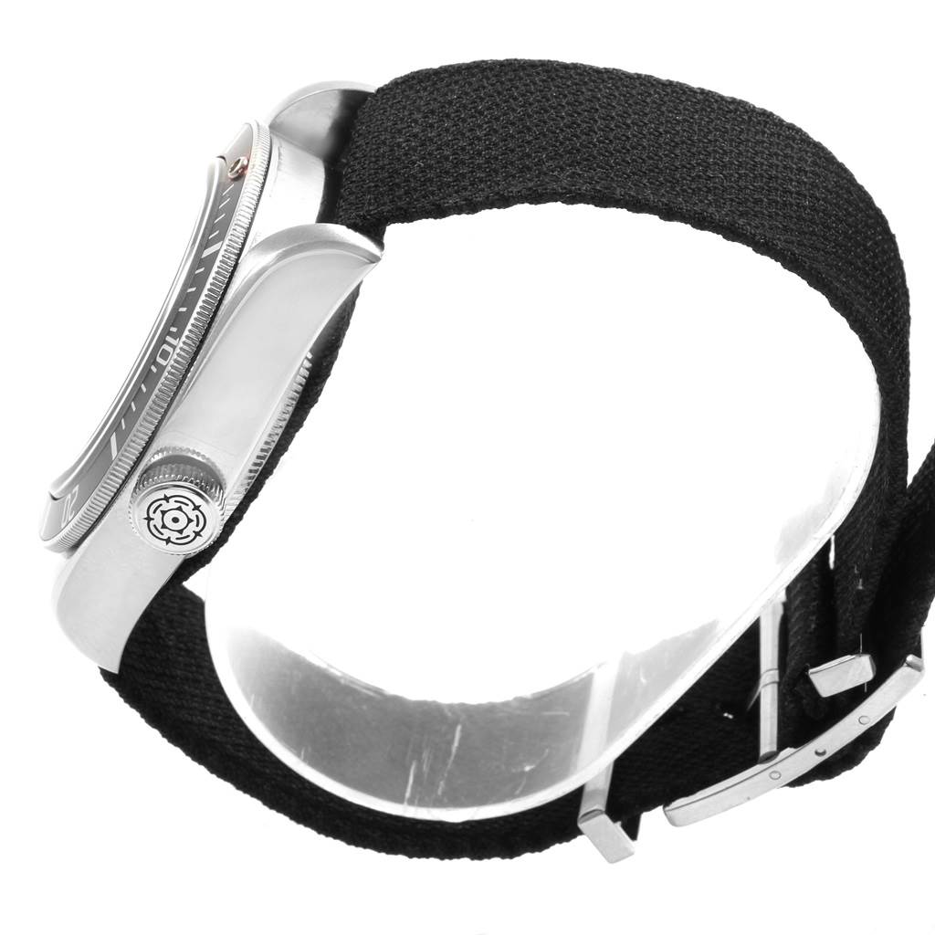 The image shows a side view of the Tudor Heritage Black Bay 79230 Men's Stainless Steel Black Dial 79230 Men's Stainless Steel Black Dial watch, highlighting the crown and the NATO strap.