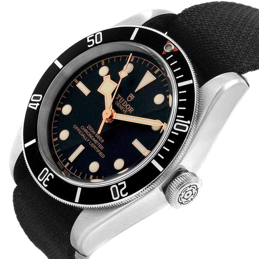 The image shows a close-up, side-angled view of the Tudor Heritage Black Bay 79230 Men's Stainless Steel Black Dial 79230 Men's Stainless Steel Black Dial watch face and crown with a black strap.