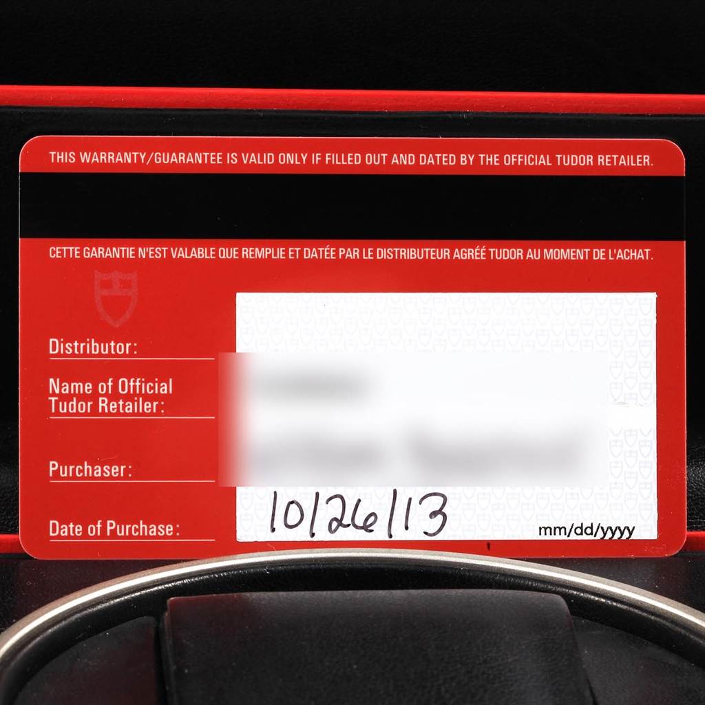 The image shows the warranty card for the Tudor Grantour 20500N Men's Stainless Steel Silver Dial 20500N Men's Stainless Steel Silver Dial model, with partial view of the watch box below it.